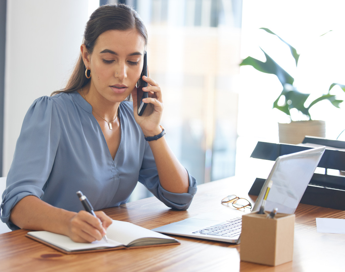 business-woman-writing-and-phone-small-size