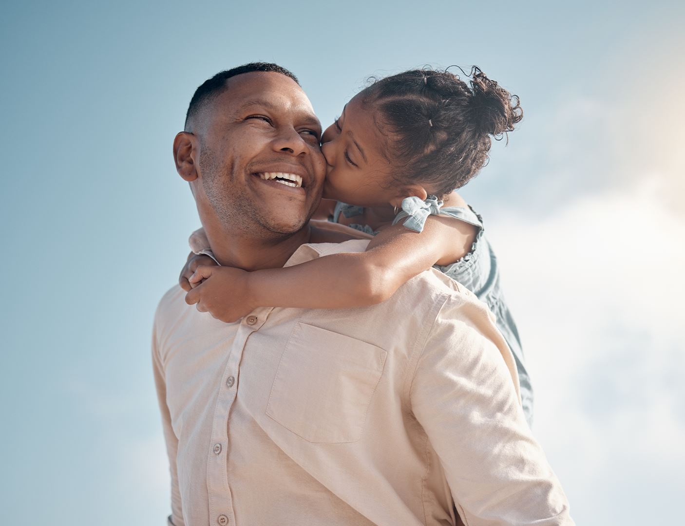 father lifting his daughter and smiling